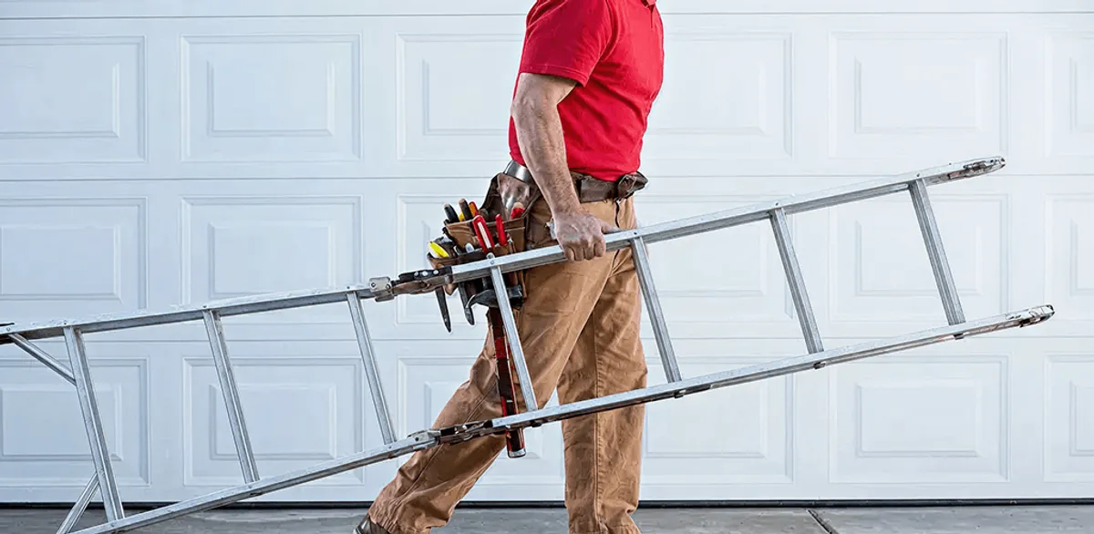 Garage door repair technician arriving with tools and ladder in Tampa, FL