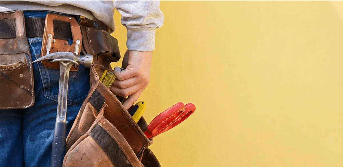 Handyman with tool belt ready for home repairs and maintenance in Tampa, FL