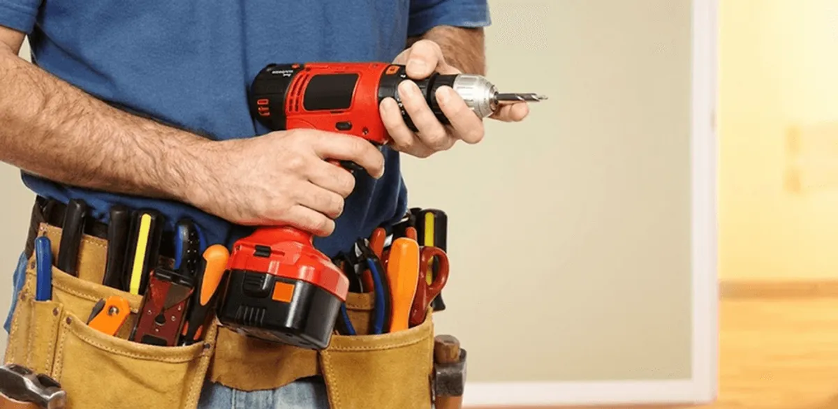 Handyman holding a power drill for home repairs and installations in Tampa, FL